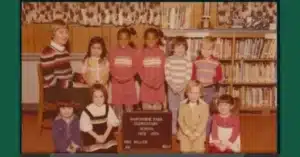 An old photo from the 1970s of a group of kindergarteners in a classroom.